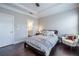 Light-filled bedroom showcases hardwood floors, tray ceilings, and a quaint chair at 2048 Rockledge Ne Rd, Atlanta, GA 30324