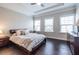 Well-lit bedroom with three windows, hardwood floors, and tray ceilings is calm and inviting at 2048 Rockledge Ne Rd, Atlanta, GA 30324
