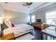 Bedroom with tray ceiling, hardwood floors, two windows, comfortable bed, and a ceiling fan at 2048 Rockledge Ne Rd, Atlanta, GA 30324