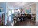 Bright dining area with modern lighting, a dark wood table, and an open view into the stylish kitchen at 2048 Rockledge Ne Rd, Atlanta, GA 30324