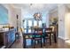 Open dining room features stylish furniture and decor with views to the open living room and stairwell at 2048 Rockledge Ne Rd, Atlanta, GA 30324