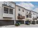 Townhome exterior featuring a private garage, balcony, and neutral siding with classic architectural details at 2048 Rockledge Ne Rd, Atlanta, GA 30324