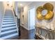 Stylish foyer with hardwood floors, staircase, and decorative mirror adding character to the entrance at 2048 Rockledge Ne Rd, Atlanta, GA 30324