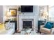 Comfortable living room features a fireplace with a TV, tasteful furnishings, and elegant decor elements at 2048 Rockledge Ne Rd, Atlanta, GA 30324