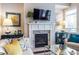 Cozy living room features a fireplace with a TV, stylish decor, and lots of natural light from a bright window at 2048 Rockledge Ne Rd, Atlanta, GA 30324