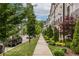 Street view of townhomes with well-maintained sidewalks and landscaping with lush trees and manicured bushes at 2048 Rockledge Ne Rd, Atlanta, GA 30324