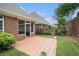 The home features a tiled patio and lush backyard with manicured greenery and a privacy fence at 2050 Woodberry Run Dr, Snellville, GA 30078