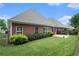 The home features a lush backyard with manicured greenery and a tiled patio at 2050 Woodberry Run Dr, Snellville, GA 30078