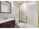 A cozy bathroom featuring a vanity, toilet, and shower/tub combination with a frosted glass enclosure at 2050 Woodberry Run Dr, Snellville, GA 30078