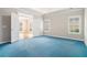 Spacious bedroom with a tray ceiling, plush carpet, and natural light from shuttered windows at 2050 Woodberry Run Dr, Snellville, GA 30078