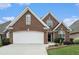 Beautiful brick home with a well-manicured lawn and a two-car garage, offering classic curb appeal at 2050 Woodberry Run Dr, Snellville, GA 30078