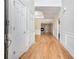 Inviting hallway featuring gleaming hardwood floors, elegant moldings, and seamless flow into the living spaces at 2050 Woodberry Run Dr, Snellville, GA 30078