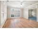 Bright living room features plantation shutters, hardwood floors, and generous sunlight at 2050 Woodberry Run Dr, Snellville, GA 30078