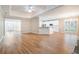 Spacious open-concept living area featuring hardwood floors, a fireplace, and a tray ceiling with fan and view to kitchen at 2050 Woodberry Run Dr, Snellville, GA 30078