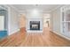 Living room showcasing a fireplace, hardwood floors, french doors, and neutral wall color at 2050 Woodberry Run Dr, Snellville, GA 30078