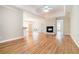 Spacious open-concept living area featuring hardwood floors, a fireplace, and a tray ceiling with fan at 2050 Woodberry Run Dr, Snellville, GA 30078
