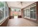 Covered brick patio with tile flooring and ceiling fan, offering a comfortable outdoor living space at 2050 Woodberry Run Dr, Snellville, GA 30078
