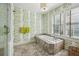 Bright bathroom featuring a soaking tub, tiled floor, and botanical wallpaper at 3086 E Pine Valley Nw Rd, Atlanta, GA 30305