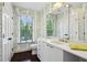 Bathroom with white vanity, brass fixtures, and leaf-patterned wallpaper at 3086 E Pine Valley Nw Rd, Atlanta, GA 30305