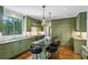 Modern kitchen featuring green cabinets, stainless steel appliances, and an island with seating at 3086 E Pine Valley Nw Rd, Atlanta, GA 30305