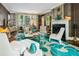 Stylish living room with fireplace, large windows, and a turquoise and cream floral rug at 3086 E Pine Valley Nw Rd, Atlanta, GA 30305