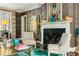 Cozy living room featuring a fireplace, elegant decor, and ample natural light at 3086 E Pine Valley Nw Rd, Atlanta, GA 30305
