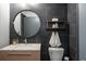Stylish bathroom showcasing contemporary vanity with marble countertop, round mirror, and modern fixtures at 480 John Wesley Dobbs Ne Ave # 418, Atlanta, GA 30312