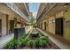 Exterior courtyard featuring a fountain, lush greenery, and a walkway between buildings at 480 John Wesley Dobbs Ne Ave # 418, Atlanta, GA 30312