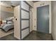 View of bedroom and hallway showcases ceiling fan, door, and frosted glass sliding doors at 480 John Wesley Dobbs Ne Ave # 418, Atlanta, GA 30312