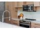Close-up view of kitchen showcasing stainless steel appliances, modern countertops, and light wood cabinetry at 480 John Wesley Dobbs Ne Ave # 418, Atlanta, GA 30312