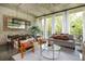 Bright living room features a neutral color palette, dining space, concrete ceilings and large windows overlooking the greenery at 480 John Wesley Dobbs Ne Ave # 418, Atlanta, GA 30312