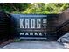 An artsy black sign for Krog St. Market with stark white painted letting along a wall with concrete and steps at 480 John Wesley Dobbs Ne Ave # 418, Atlanta, GA 30312