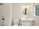 Bright bathroom featuring a shower and vanity with a round mirror and modern light fixtures at 603 E Paces Ferry Ne Rd, Atlanta, GA 30305