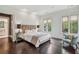 Spacious bedroom with hardwood floors, soft lighting, and windows providing backyard views at 603 E Paces Ferry Ne Rd, Atlanta, GA 30305