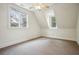 Bright and airy bedroom with neutral carpet, two windows, and sloped ceilings at 603 E Paces Ferry Ne Rd, Atlanta, GA 30305