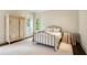 Cozy bedroom featuring a wrought iron bed frame, an antique armoire, and hardwood floors at 603 E Paces Ferry Ne Rd, Atlanta, GA 30305