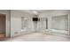 Spacious bonus room featuring large mirrors, a TV, and soft carpeting, perfect for recreation or fitness at 603 E Paces Ferry Ne Rd, Atlanta, GA 30305