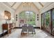 Bright dining room with vaulted ceiling, large windows overlooking the yard, and hardwood floors at 603 E Paces Ferry Ne Rd, Atlanta, GA 30305