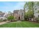 Charming brick and stone home with manicured lawn, complemented by mature trees under a partly cloudy sky at 603 E Paces Ferry Ne Rd, Atlanta, GA 30305