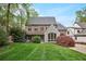 Beautiful brick home with stone accents, a manicured lawn, and mature landscaping for curb appeal at 603 E Paces Ferry Ne Rd, Atlanta, GA 30305