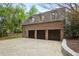 Spacious three-car garage with brick exterior, offering ample parking and storage space at 603 E Paces Ferry Ne Rd, Atlanta, GA 30305
