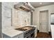 Gourmet kitchen features a professional-grade Viking range, tile backsplash, stone counters, and custom cabinetry at 603 E Paces Ferry Ne Rd, Atlanta, GA 30305