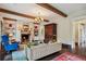 Bright living room with fireplace, beamed ceilings, and hardwood flooring, bathed in natural light at 603 E Paces Ferry Ne Rd, Atlanta, GA 30305