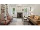 Bright living room with built-in bookshelves, a fireplace, and neutral decor at 603 E Paces Ferry Ne Rd, Atlanta, GA 30305