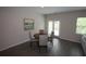 Dining area with a wood table, gray chairs, and wood-look floors at 6348 Lanier Harbor Lndg, Buford, GA 30518