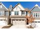 Charming two-story townhome with a brick facade and a two-car garage at 6348 Lanier Harbor Lndg, Buford, GA 30518