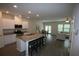 Open concept kitchen with granite countertops flows into dining and living areas at 6348 Lanier Harbor Lndg, Buford, GA 30518