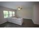 Bright living room featuring a ceiling fan, large windows, and a plush couch at 6348 Lanier Harbor Lndg, Buford, GA 30518
