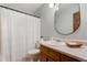 Bathroom features a white shower curtain and rounded mirror at 258 Lancaster Cir, Marietta, GA 30066