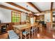 Spacious dining room featuring wood floors, beamed ceilings, large windows, and seating for eight at 258 Lancaster Cir, Marietta, GA 30066